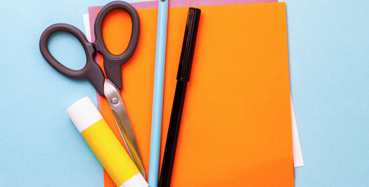 Construction paper, scissors, glue, and pens, ready for a fun valentines day craft. 