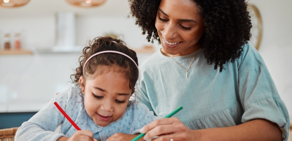 Mother and daughter working together on school work. 