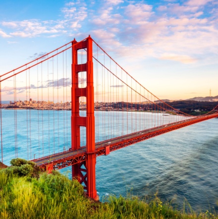 The golden gate bridge with a beautiful sunset in the background. 