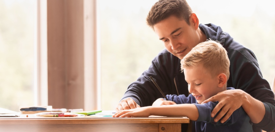 A dad helping his son to read. 