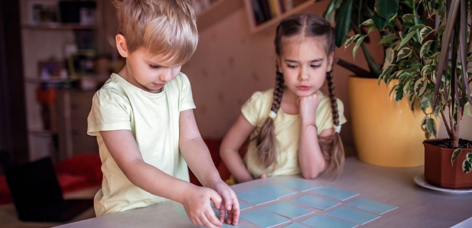 Two children playing a matching game. 