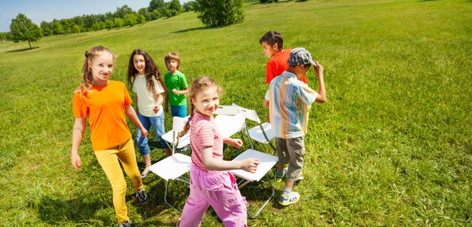 Children playing musical chairs while placing sight words on the chairs. 