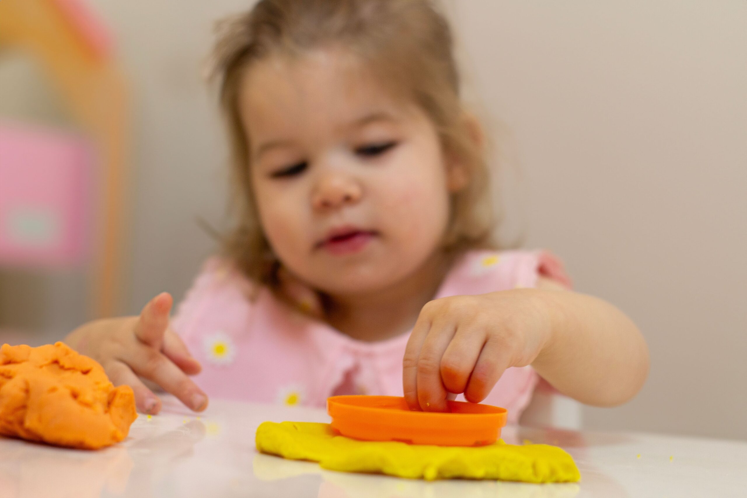 A young girl stamping letter into playdough for this fun sight word activity. 