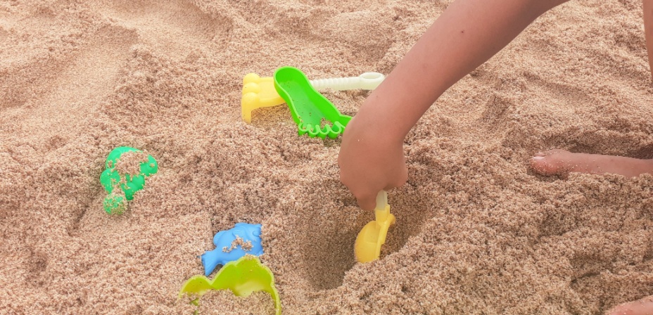 A child digging in the sand looking for sight words in this fun sight word activity for preschoolers. 