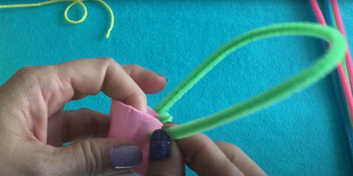 Adding a pipe cleaner handle to the little Easter Egg basket. 