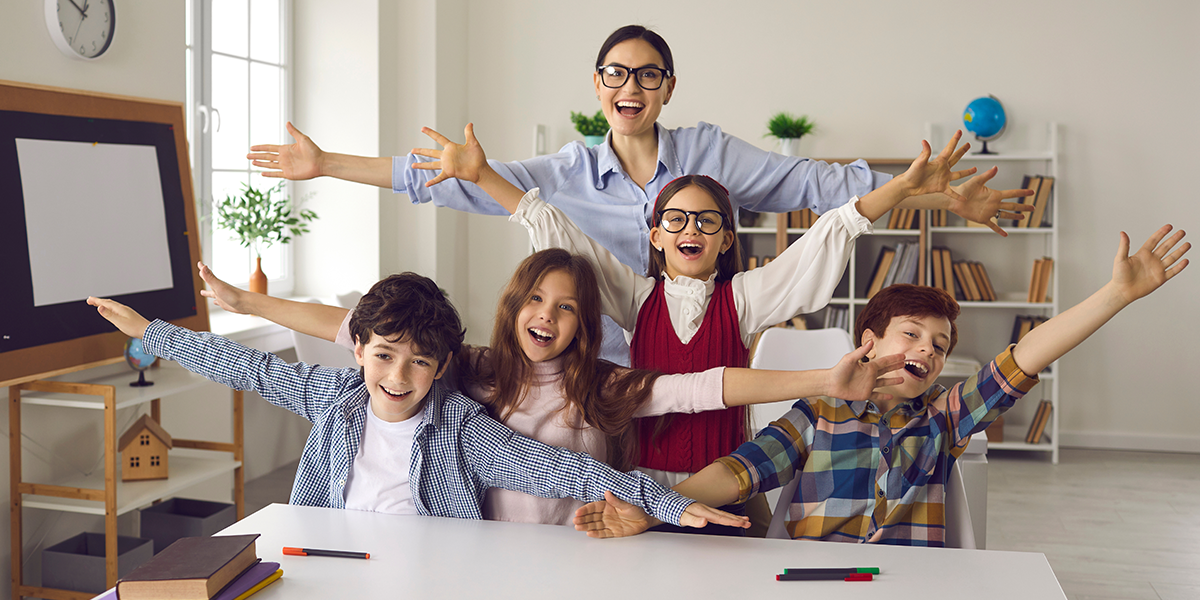 Children and teacher celebrating in a home classroom.