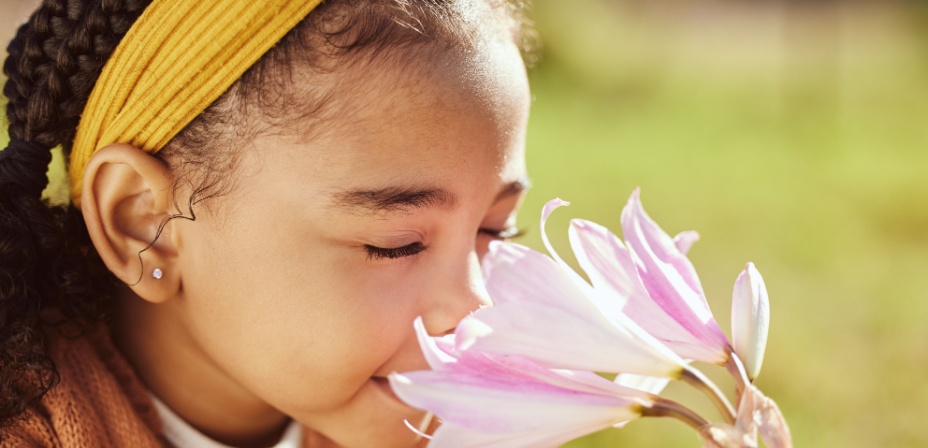 A child smelling a beautiful flower. 